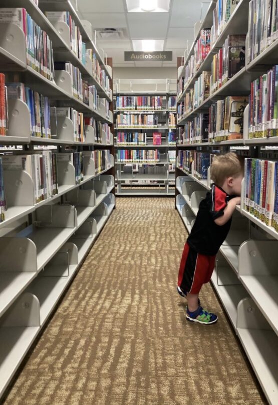 child in book shelves