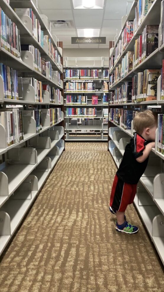 child in book shelves